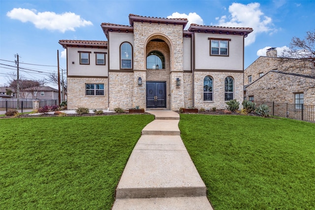 mediterranean / spanish-style home featuring a front yard