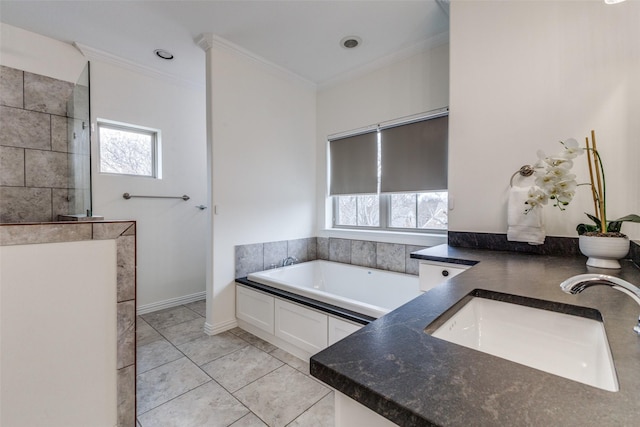 bathroom featuring crown molding, a bath, tile patterned flooring, and vanity