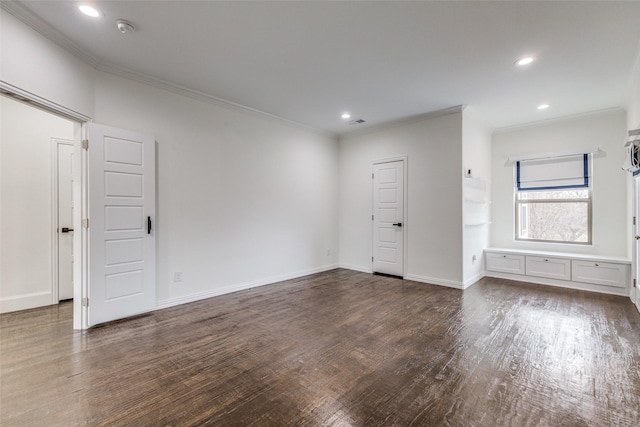 spare room with crown molding and dark hardwood / wood-style floors