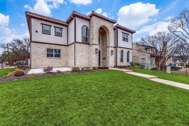 mediterranean / spanish-style house with a front yard