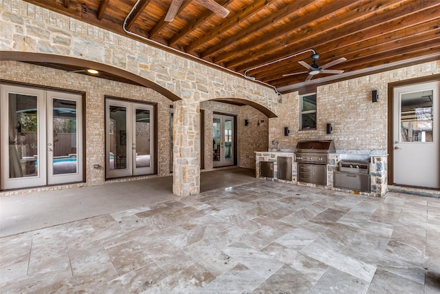 view of patio / terrace with area for grilling, a grill, ceiling fan, and french doors