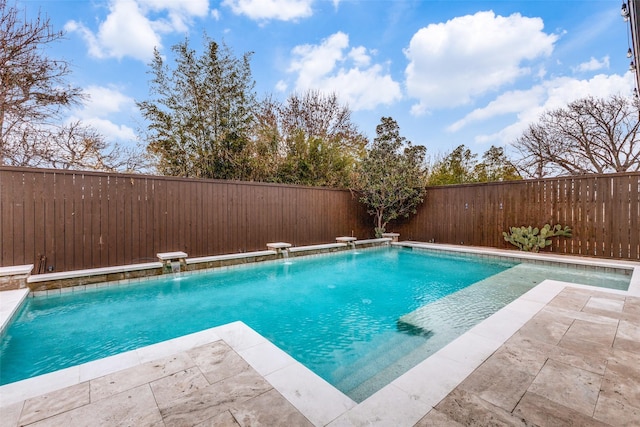 view of swimming pool with pool water feature and a patio