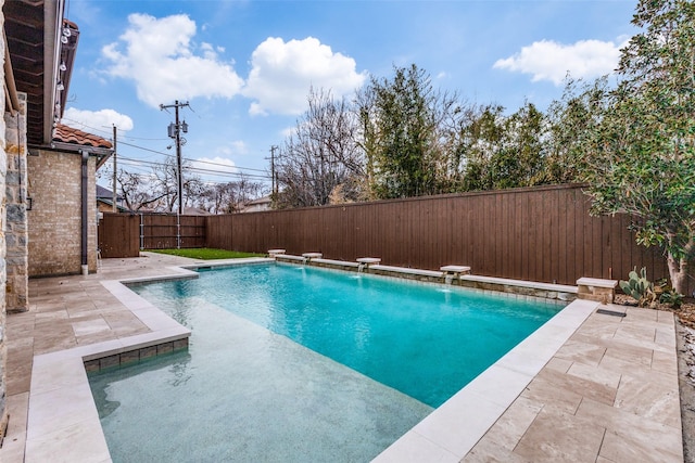 view of pool with pool water feature and a patio area