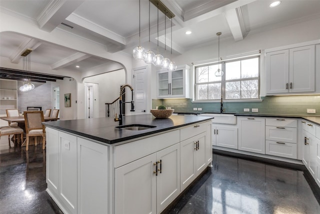 kitchen with sink, white cabinetry, and hanging light fixtures