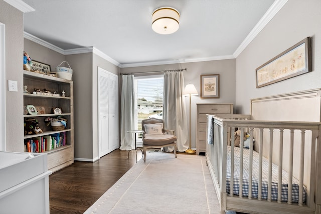 bedroom with dark wood-type flooring, a closet, and crown molding