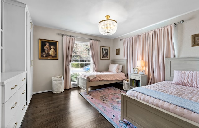 bedroom with dark hardwood / wood-style flooring and a notable chandelier