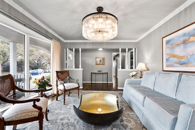 living room featuring an inviting chandelier, ornamental molding, and hardwood / wood-style floors