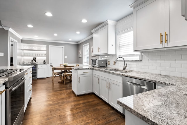 kitchen featuring white cabinetry, light stone counters, and oven