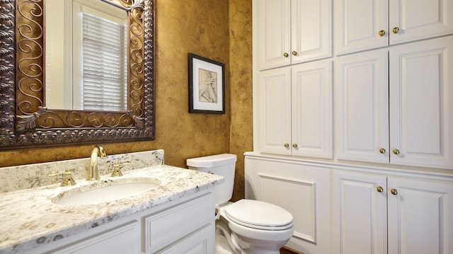 bathroom with toilet and vanity