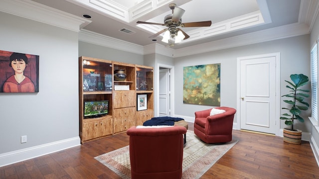 sitting room featuring ceiling fan, crown molding, wood-type flooring, and a tray ceiling