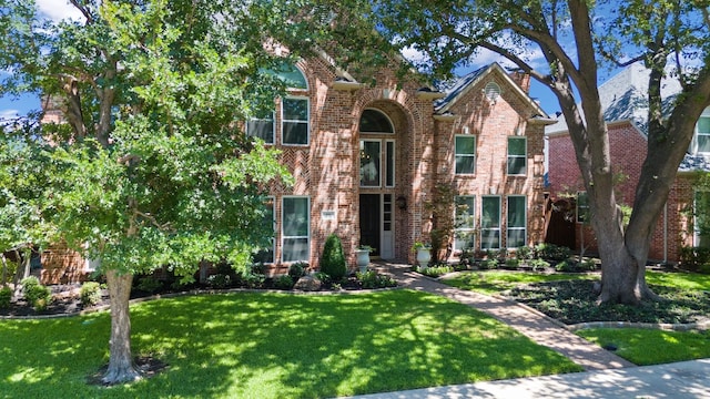 view of property featuring a front lawn