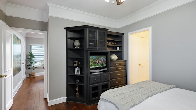 bedroom with dark wood-type flooring and ornamental molding