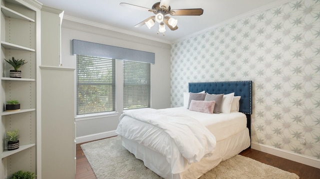 bedroom featuring ceiling fan, dark hardwood / wood-style floors, and ornamental molding