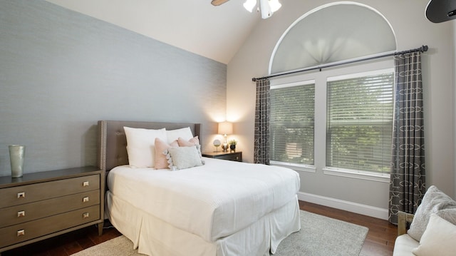 bedroom with ceiling fan, lofted ceiling, and dark hardwood / wood-style floors