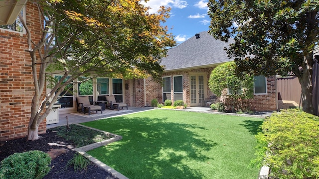 back of house with a patio area and a yard