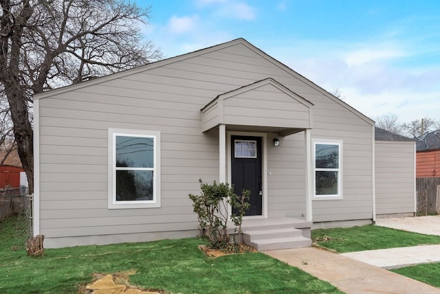 bungalow-style house with a front yard