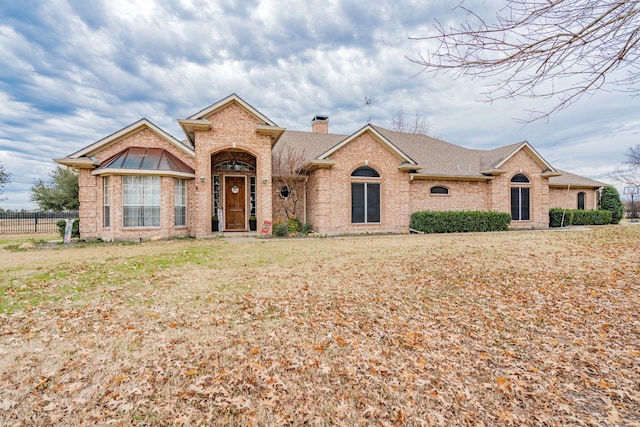 ranch-style house featuring a front lawn