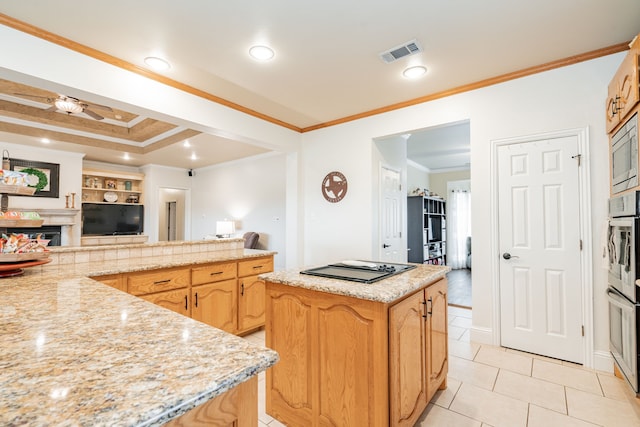 kitchen with a kitchen island, ceiling fan, ornamental molding, light stone counters, and light tile patterned floors