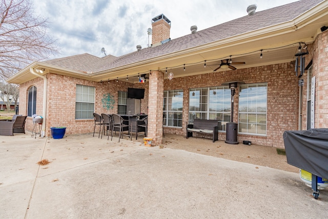 rear view of property with ceiling fan and a patio