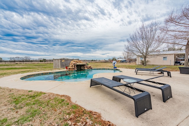 view of swimming pool with a yard and a patio