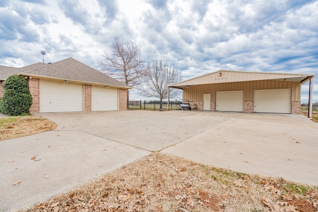 view of side of property featuring a garage and an outbuilding