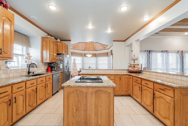 kitchen featuring appliances with stainless steel finishes, a kitchen island, sink, ornamental molding, and kitchen peninsula