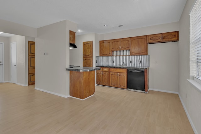 kitchen with black dishwasher and light hardwood / wood-style floors