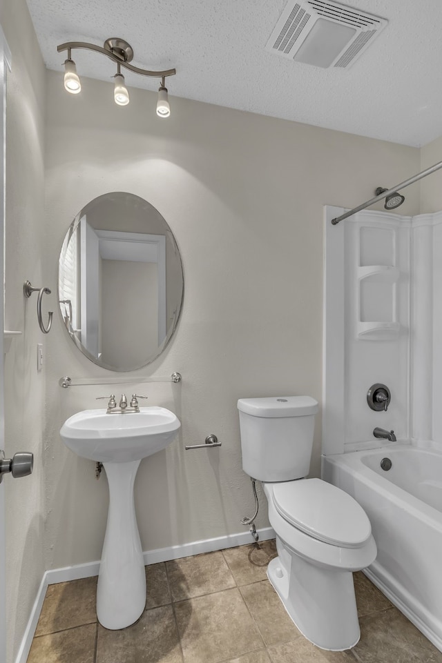 full bathroom with a textured ceiling, toilet, tile patterned flooring, and shower / bathing tub combination