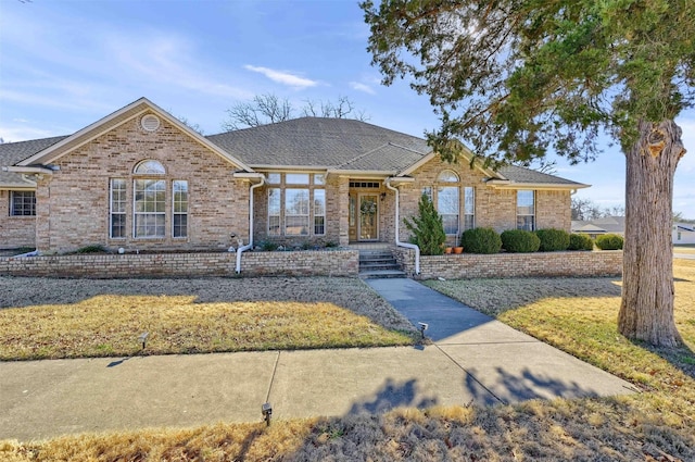 ranch-style home featuring a front yard