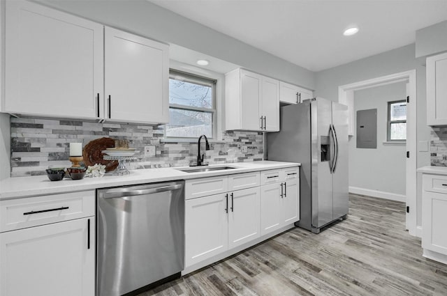 kitchen with white cabinets, appliances with stainless steel finishes, and sink