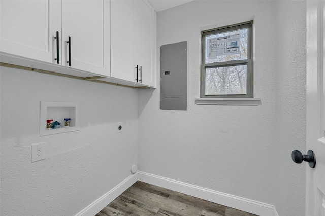 washroom featuring hardwood / wood-style floors, cabinets, washer hookup, hookup for an electric dryer, and electric panel