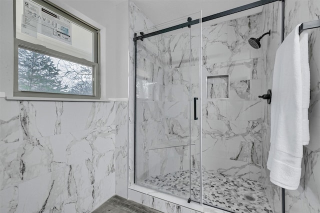 bathroom with tile walls and an enclosed shower