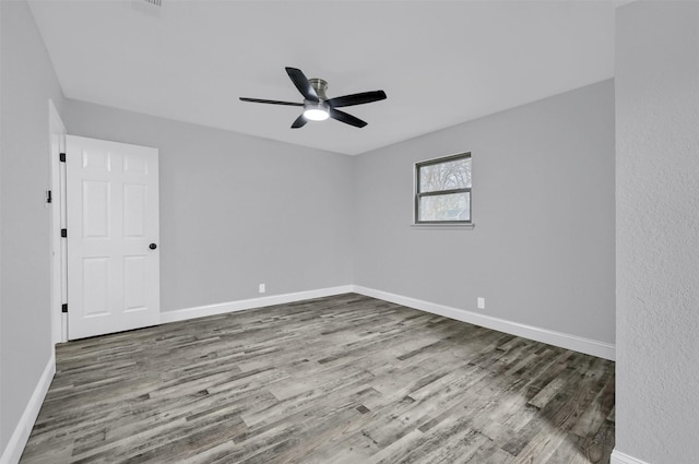 empty room featuring ceiling fan and hardwood / wood-style floors