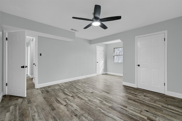 spare room with ceiling fan and dark hardwood / wood-style flooring