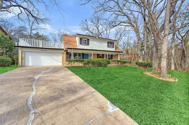 front facade with a front yard, covered porch, and a garage