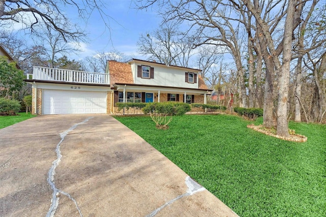 view of front property featuring a front lawn, covered porch, and a garage