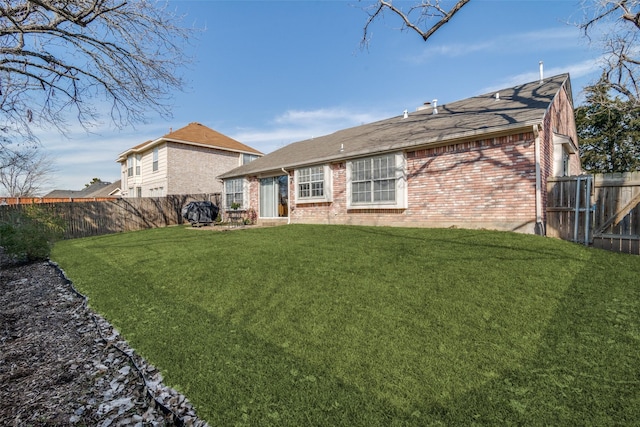 rear view of property with a yard