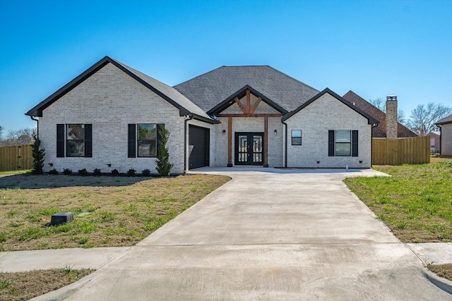 view of front facade with a front yard and french doors