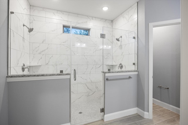 bathroom featuring a shower with door