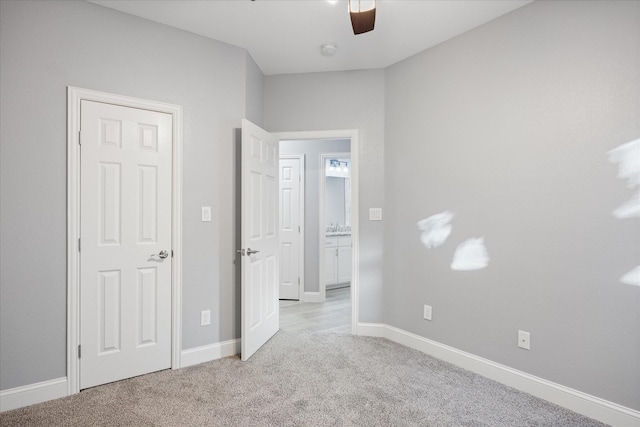 unfurnished bedroom with ceiling fan and light carpet