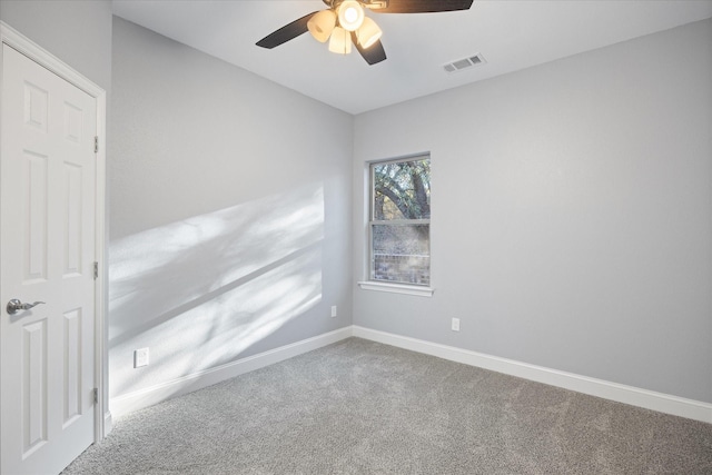 empty room featuring ceiling fan and carpet flooring