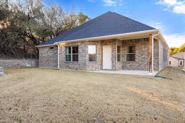 back of property with a patio and a yard