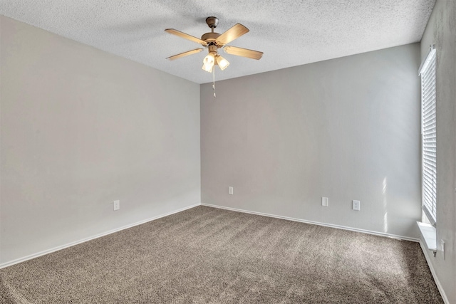 empty room with a textured ceiling, ceiling fan, and carpet floors