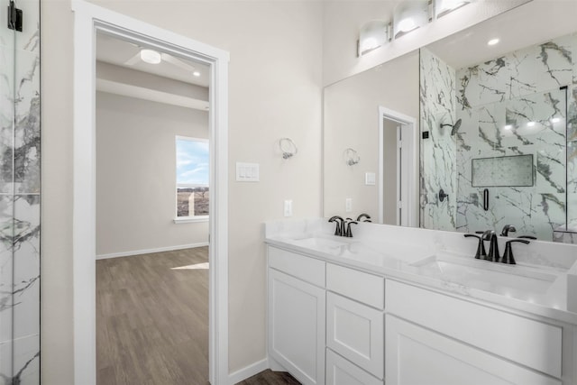 bathroom with an enclosed shower, vanity, and wood-type flooring