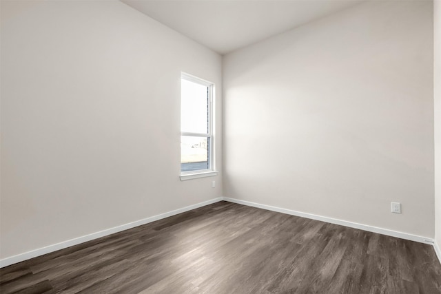 unfurnished room featuring dark wood-type flooring