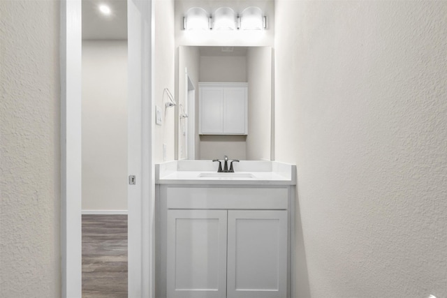 bathroom with vanity and hardwood / wood-style floors