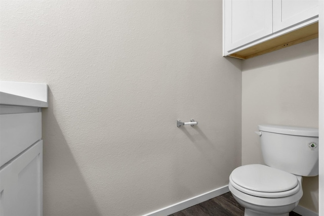 bathroom with hardwood / wood-style floors and toilet