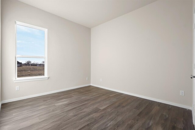 spare room featuring dark hardwood / wood-style flooring