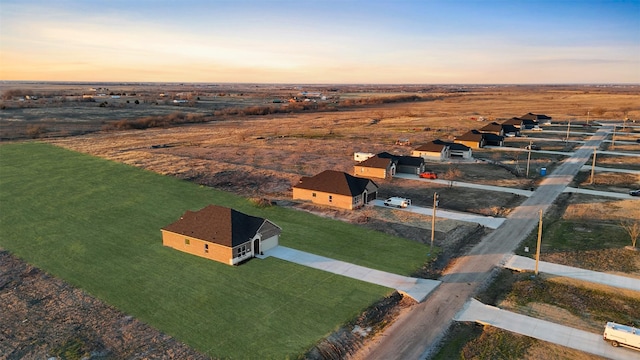 aerial view at dusk featuring a rural view