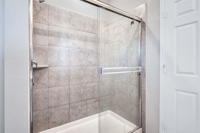 bathroom with a shower with shower door